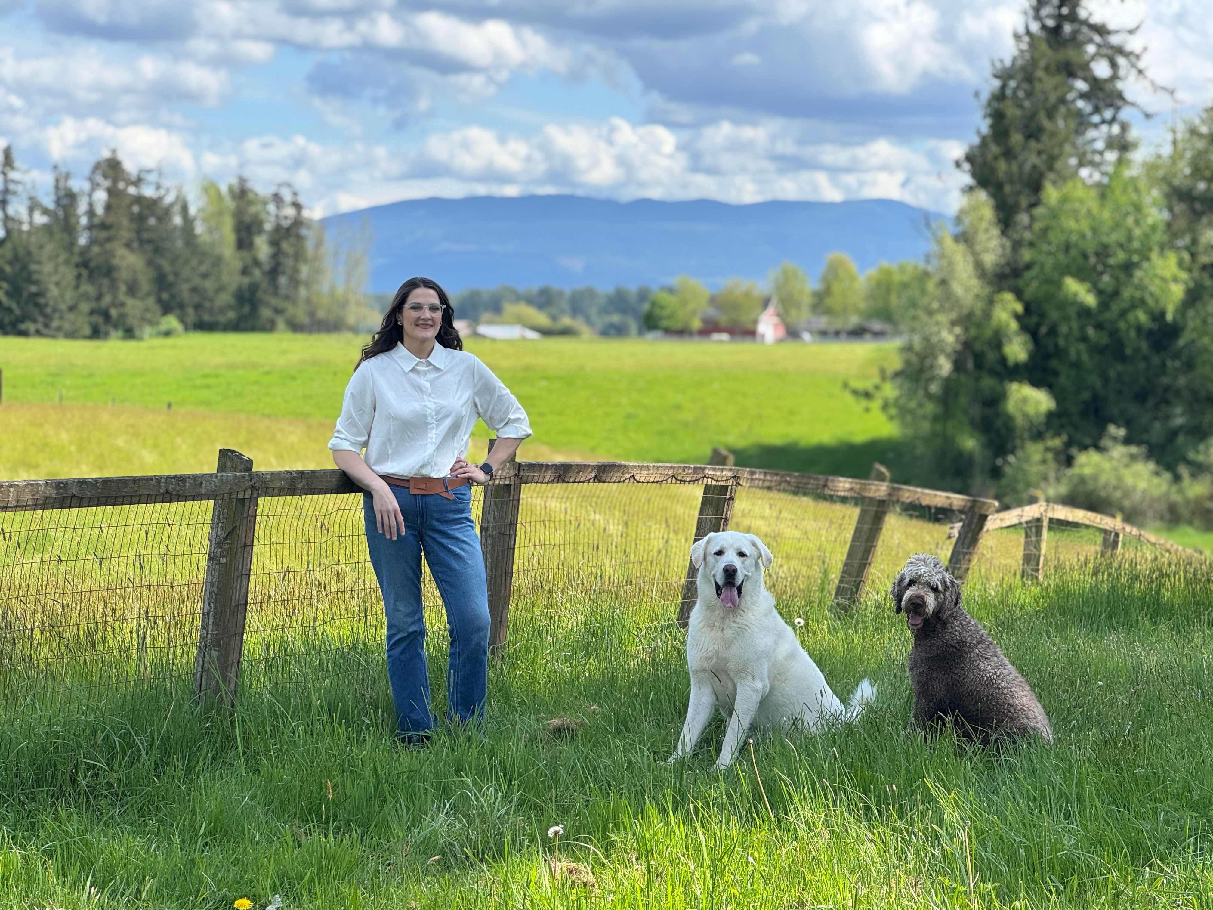 Jessica Rienstra with her dogs in rural Whatcom County, showing her connection to the local community
